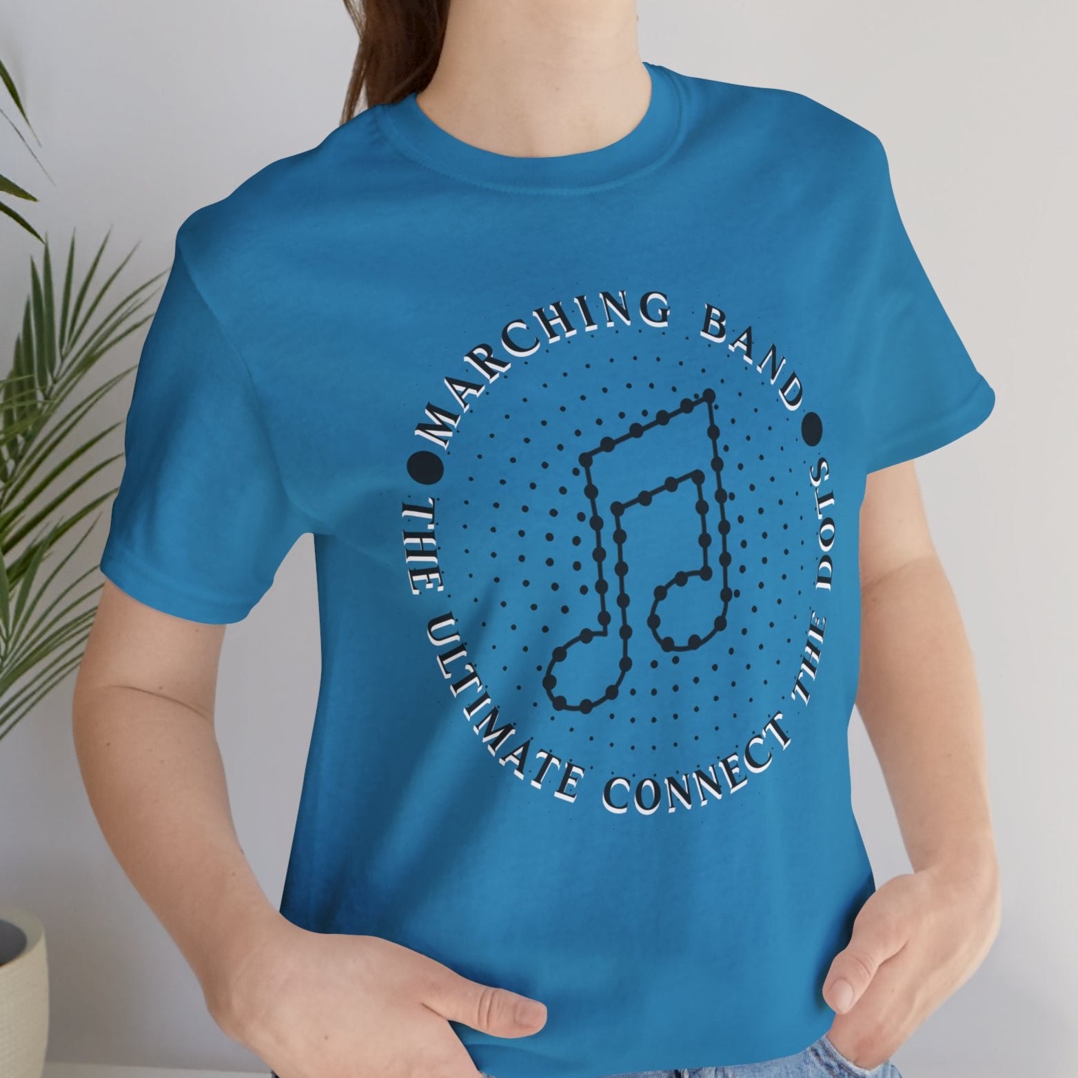 Person wearing a blue t-shirt with a musical note design and text.