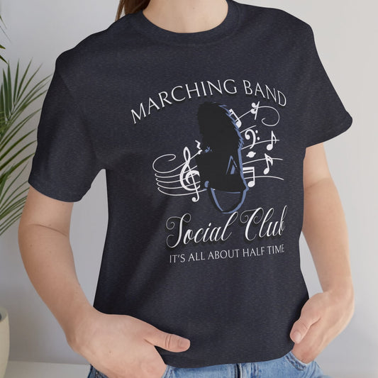 Person wearing a black t-shirt with 'Marching Band Social Club' design, standing indoors.
