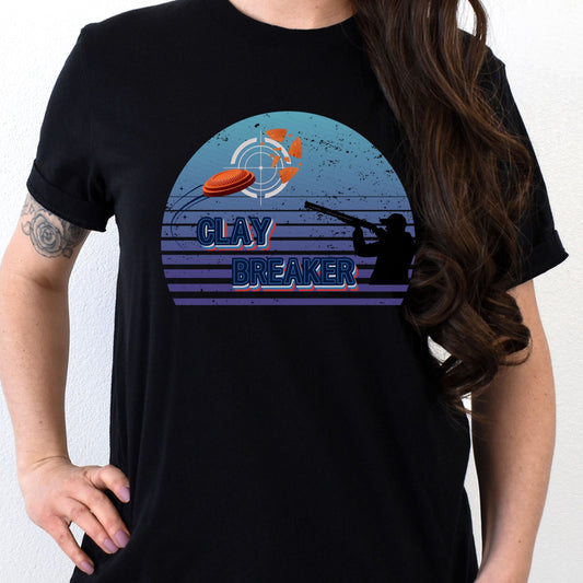 A woman wearing a black t-shirt with a 'Clay Breaker' text and an illustration of a clay pigeon thrower.