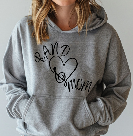 A woman wearing a gray hoodie with 'BAND MOM' text and a heart symbol on the front.